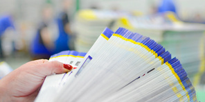 Woman thumbing through brochures that were printed